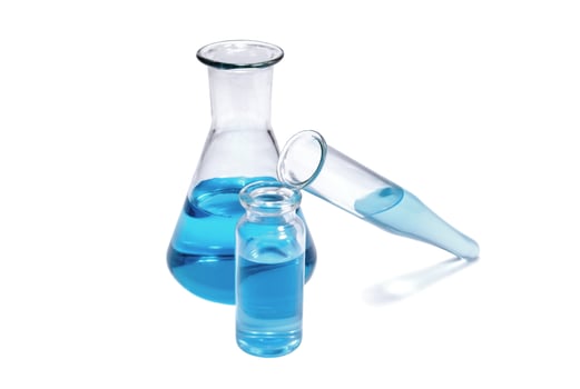 Flask, vial and test tube with blue liquid on white background photo