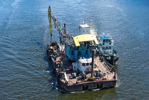 Floating crane and river tug photo