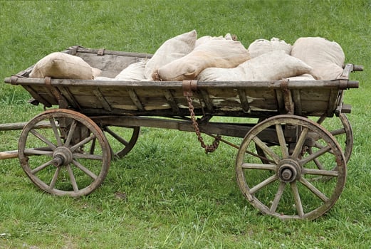 Old wood cart loaded with sacks photo