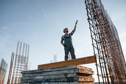 Communicating with other people. Man is working on the construction site at daytime photo