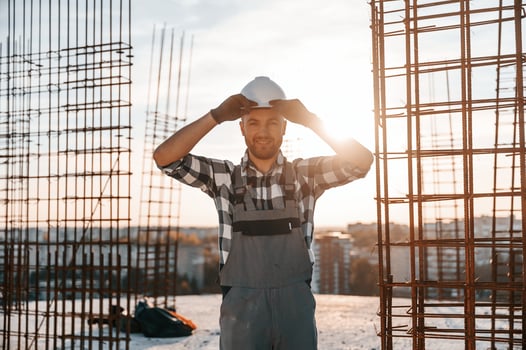 Standing in a beautiful sunlight., Man is working on the construction site at daytime photo
