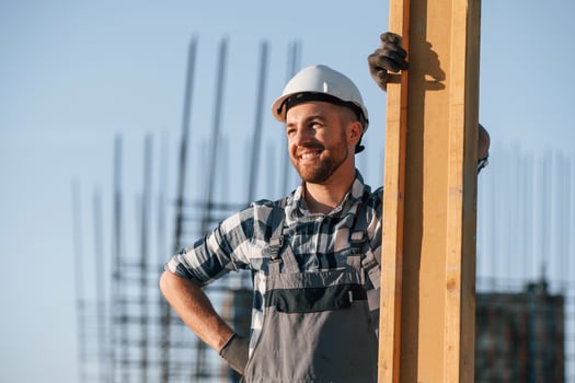 Standing and posing. Man is working on the construction, site at daytime photo