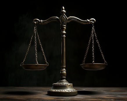 Bronze Balance Scale on Dark Wooden Surface photo