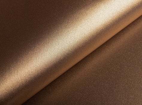 Elegant paper background with a glossy, pearlescent texture and a shimmering gradient effect. Warm photo