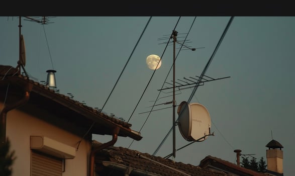 Moonlit rooftop antennas photo