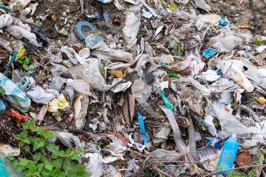 wild garbage dump. residual glass, plastics photo