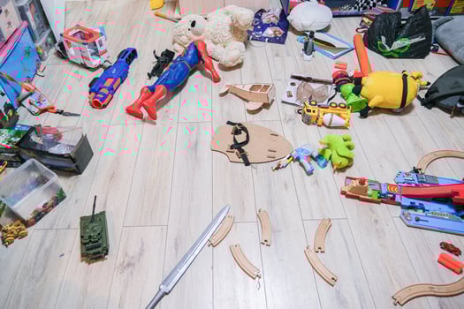 A messy room with toys scattered all over the floor photo