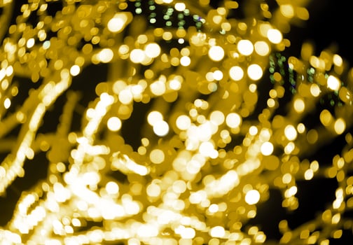 Christmas holiday lights glowing with golden sparkle, glitter, and festive magic. Elegant garland, photo