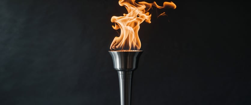 Beautiful torch with burning fire on black background photo