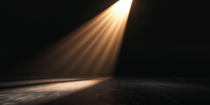 A spotlight shines on a dark floor photo