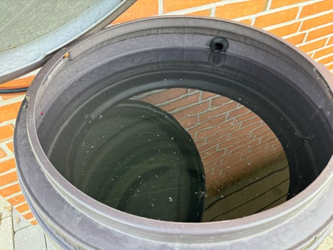 Water-Filled Barrel Against Brick Wall photo