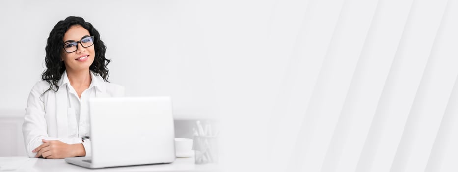 Successful Businesswoman. Portrait of confident mexican lady sitting at desk, looking at camera, copy space photo