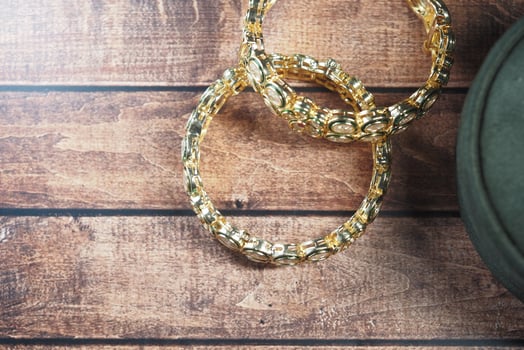 Beautiful gold bangles on a wooden table showcase elegance and style photo