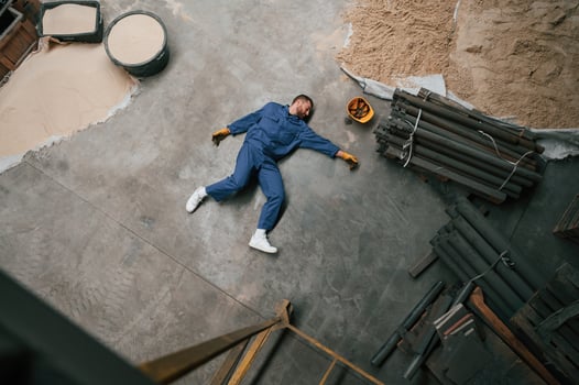 Top, view of dead factory worker that lying on the ground. Conception of safety, bad accident photo