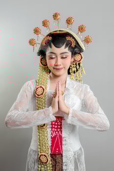Indonesian bride in Solo Putri attire stands gracefully photo
