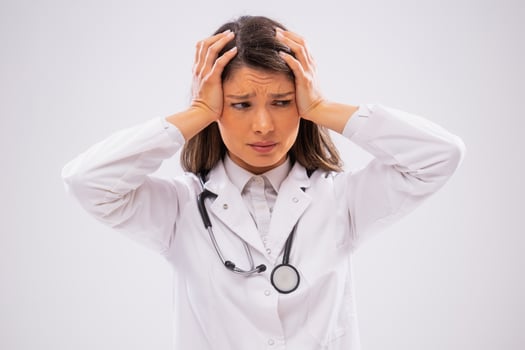 Studio shot portrait of anxious anxious doctor who is exhausted. photo