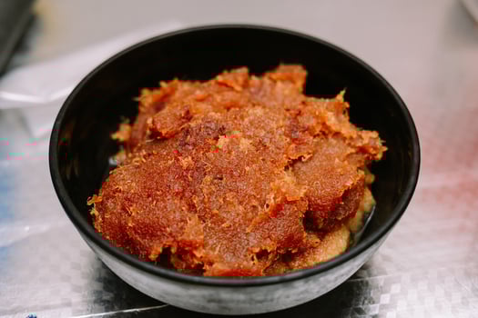 Delicious caramelized coconut jam served in a bowl for a delightful treat photo