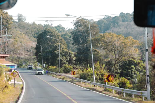 Enjoy a magnificent scenic road journey that takes you through lush greenery and majestic hills photo