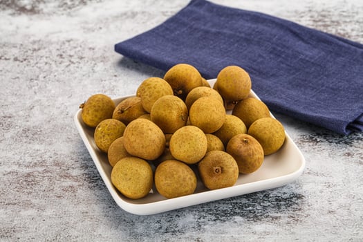 A white plate with a bowl of kiwis on it photo