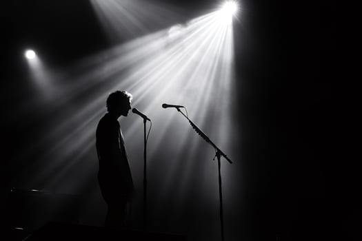 Singer performing live on stage under spotlights photo