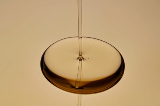 The texture of the flowing oil on a golden background. photo