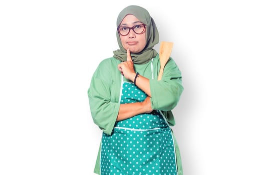Thoughtful Muslim Woman Chef Holding Wooden Spatula photo