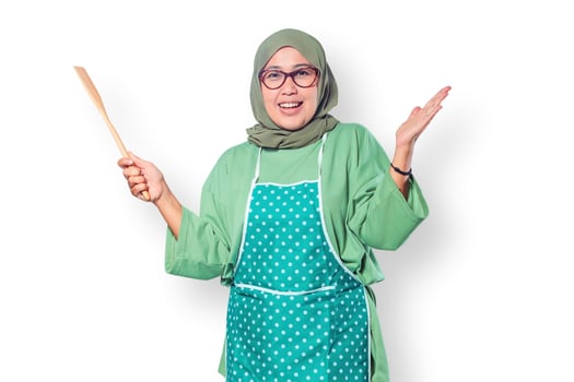 Happy Muslim Woman Cooking with Wooden Spatula photo