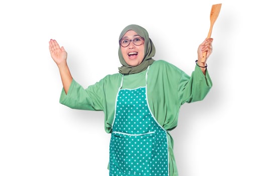 Happy Muslim Woman Chef Holding Wooden Spatula and Smiling photo