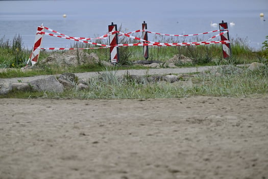 Caution Tape Marking Restricted Area by Water photo
