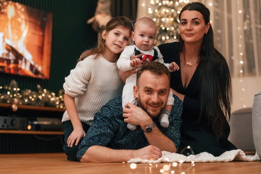 Happy family is sitting together, at home. Celebrating New Year photo