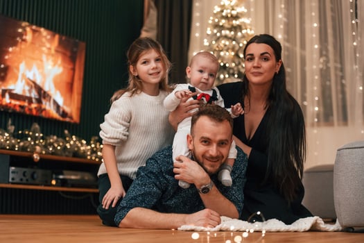 Happy family is ,sitting together at home. Celebrating New Year photo