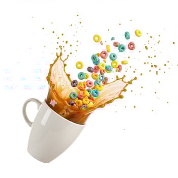 A cup of coffee with cereal and milk splashing out photo