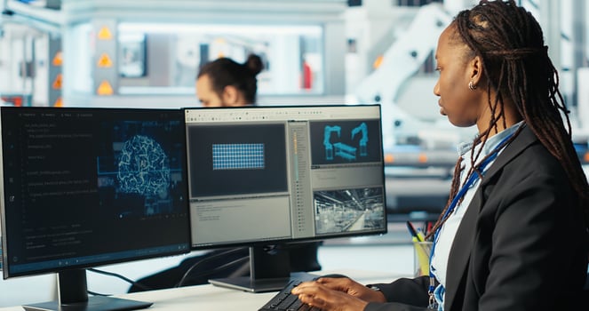 Photovoltaics programmer using AI technology to monitor system performance. Solar panels manufacturing plant developer using artificial intelligence to track energy production, camera B photo