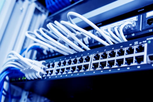 Network switch and ethernet cables in red and white colors. Data Center photo