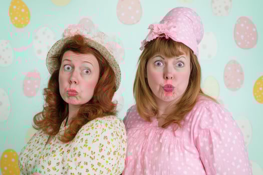 Two women in pink and white dresses with hats photo