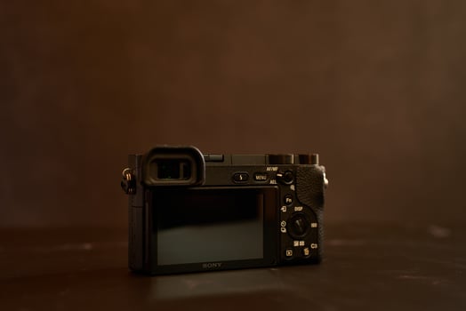 USA, Arizona - March 10, 2025. Sony A6000 mirrorless camera stands on a black table photo