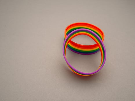 Top view of rainbow patterned wristbands is on a gray background photo