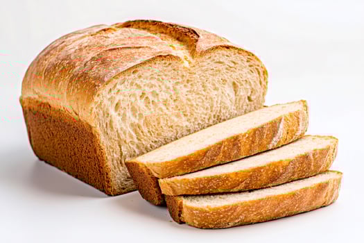 Freshly baked loaf of bread is sliced on white background. photo