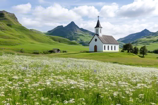 White church standing in a field of daisies and wildflowers in the Swiss Alps photo