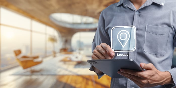 User Interacting with Location Icon on Tablet in Modern Interior Space photo