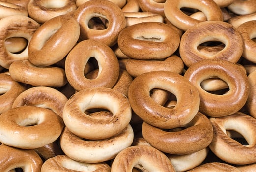 Tasty small baked bagels closeup photo