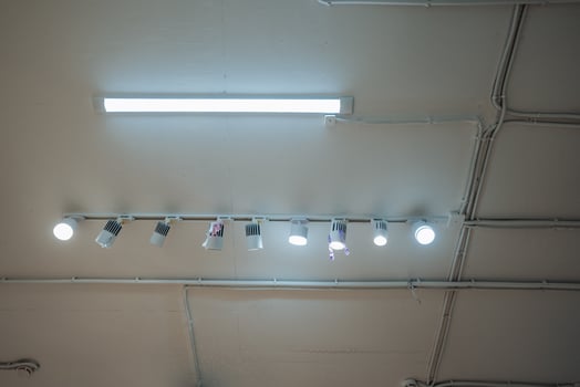 A row of lights hanging from the ceiling of a room photo