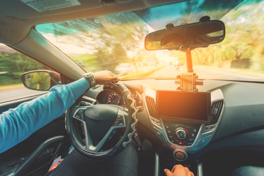View of the driver hands driving on the highway. Driver hands on the steering wheel while driving on the asphalt photo