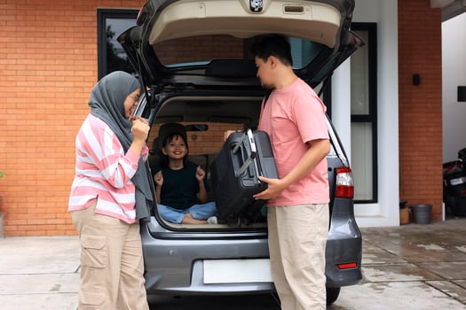 Asian Muslim Family with Kids Going on Mudik Road Trip Back Hometown During Eid Mubarak Celebration photo