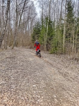 Modern motorcycle on a ride on gravel surface. Motorcycling in nature or offroad, enjoying freedom. Motorbike in the woods. Making a turn. High quality photo