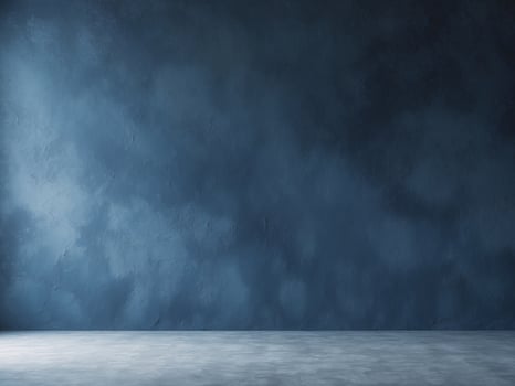 An empty room with a blue wall and concrete floor photo