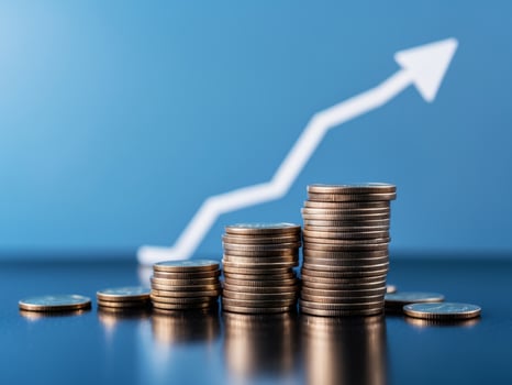 Stack coins black surface blue background are arranged growth money arrow. photo