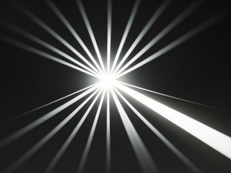A bright light shining on a black background photo