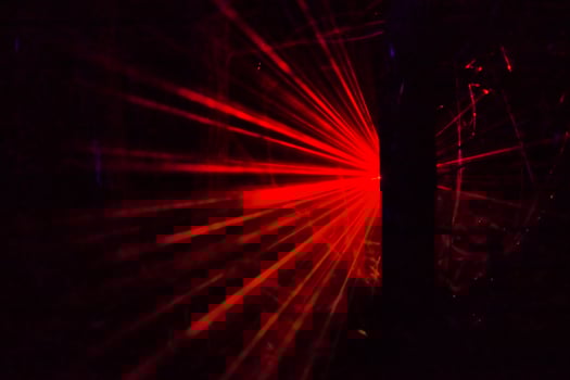 Red Laser Beams in Dark Background photo