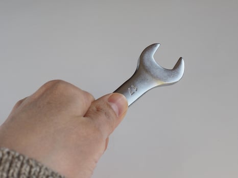 hand holds wrench spanner photo